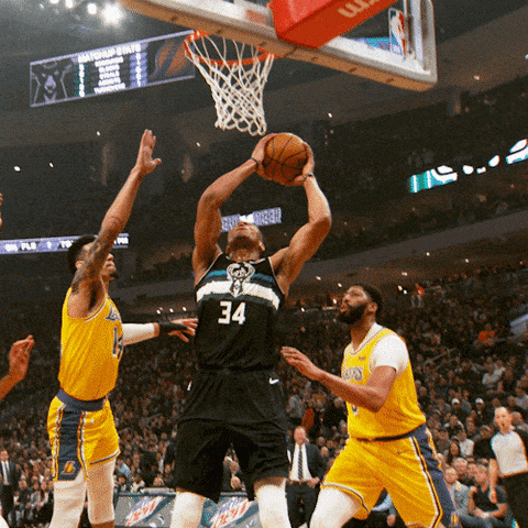 Gif of a basketball player in a black jersey dunking the ball. It then bounces off his knee and hits his opponent in the forehead.