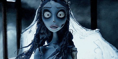The Corpse Bride looks directly into the camera with her veil flying around her, as she is silhouetted by the sky and moonlight. She begins to frown in rage.