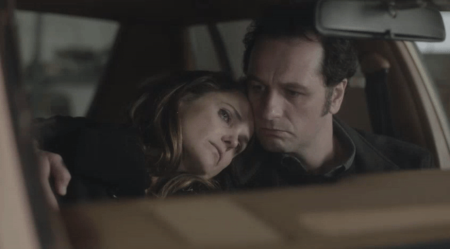 Elizabeth and Philip in The Americans sitting in a car with Elizabeth's head on Philip's shoulder