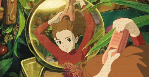 Arrietty turns a hair peg into a hair clip as she closes it around her pony tail while looking into a mirror (Arrietty, 2010)