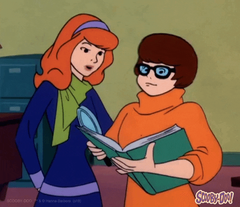 Daphne and Thelma examine a book.