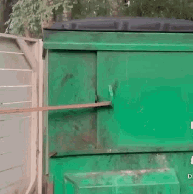 GIF of a racoon dramatically opening the sliding door of a dumpster