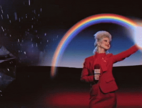 Person with tall blond hair sweeping arm over head to create rainbow with the caption "The More You Know"