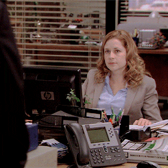 Pam from the Office raising her hand in the air.