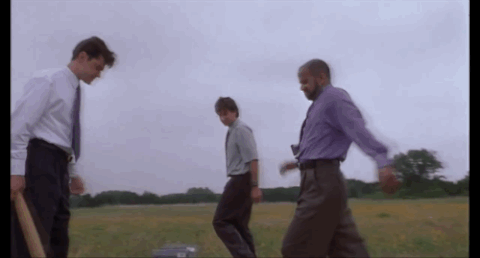 Scene from Office Space (1999). Peter, Michael, and Samir destroy a dysfunctional printer in a field.
