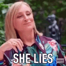 a woman in a floral shirt is making a funny face and saying she lies .