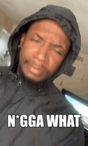 a man wearing a hooded jacket with the words " n * gga what " on the bottom