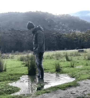Video gif. In an epic fail, a man attempting a backflip inside of a puddle falls flat on his face.