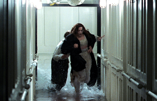GIF of Jack and Rose from Titanic running through a hallway as water floods behind them.