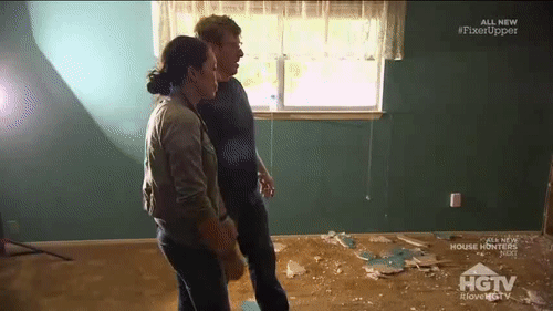 GIF of HGTV host Chip Gaines running through a wall to break it, because that is a safe way to work on a house.