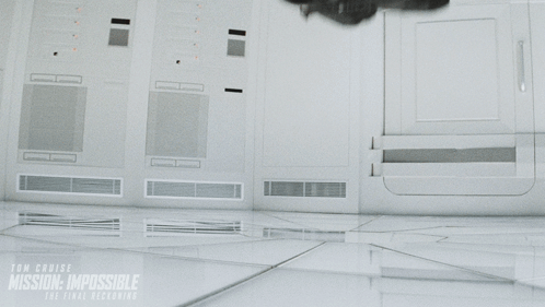 a man in a black shirt is flying through the air in a scene from the movie mission impossible
