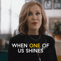 Schitt's Creek gif. Catherine O'Hara as Moira looks around, earnestly, and says, “When one of us shines, All of us shines.” with “one” and “all” emphasized.