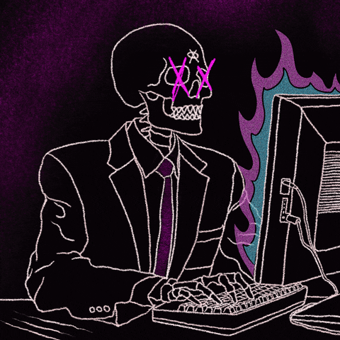 A gif of a skeleton sat at a computer which is on fire