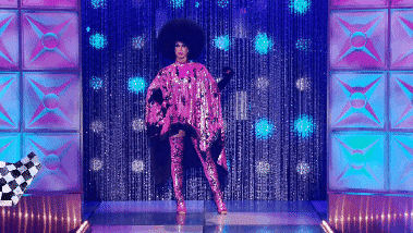 A gif of drag queen Brook Lynn Hytes doing an iconic reveal on the RuPaul's Drag Race runway, including shocked reaction faces from Michelle Visage and RuPaul