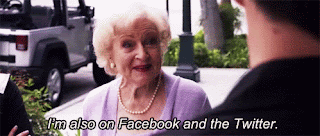 Betty White is talking to a man in the street and the caption says, 'I'm also on Facebook and the Twitter.'