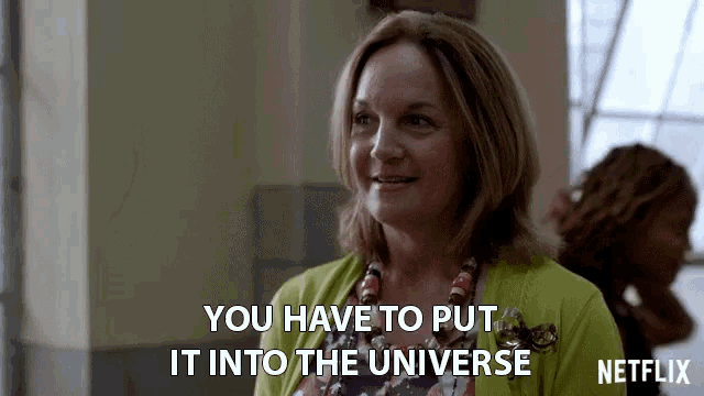 a woman in a green cardigan says you have to put it into the universe