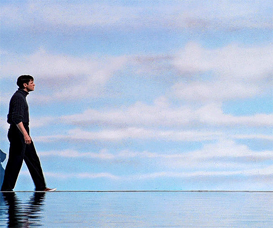 Truman in The Truman Show walks along the edge of the "world," that is the set in which he has been living.