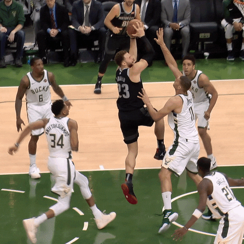 Giannis Antetokounmpo blocking a shot in an NBA game
