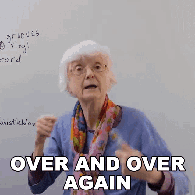 an elderly woman stands in front of a white board and says over and over again