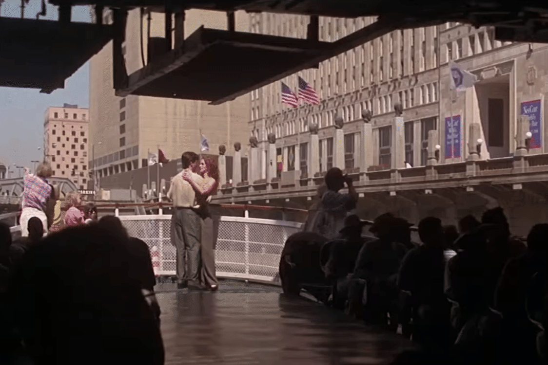 A gif from "My Best Friend's Wedding" or Michael and Julianne slow dancing on a boat as it passes under a bridge.