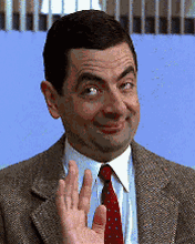 Mr. Bean waving goodbye in a subtle but comical way