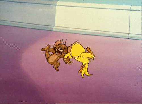 Cartoon gif. Jerry the brown mouse dances excitedly arm in arm with Quacker, a yellow bird. They kick their legs as they dance in a circle. 