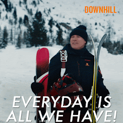 Will Ferrell is dressed in ski gear, standing on a snowy mountain, holding skis and bags. He's shouting to someone off camera, in an exaggerated way, 'Everyday is all we have.' He looks slightly deranged.
