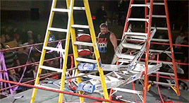 Kevin moving ladders and streamers out of the center of the ring as the image fades to black.