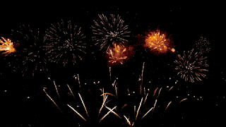 A graphic of pink and yellow figures 2024, that rotate on a black background as fireworks go off behind.