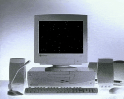 gif of a 1990s desktop computer with the flying stars screensaver