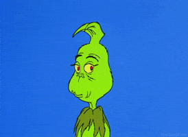 GIF of the Grinch, a green creature, smiling wickedly