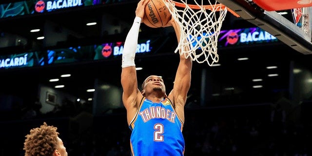 Oklahoma City Thunder guard Shai Gilgeous-Alexander (2) goes up for a dunk against the Brooklyn Nets during the first half of an NBA basketball game, Thursday, Jan. 13, 2022, in New York.