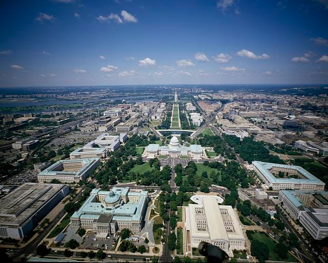 [Aerial view looking west showing Library of Congress Thomas Jefferson Building and James Madison Building, the Supreme Court, and the U.S. Capitol, Washington, D.C.]
