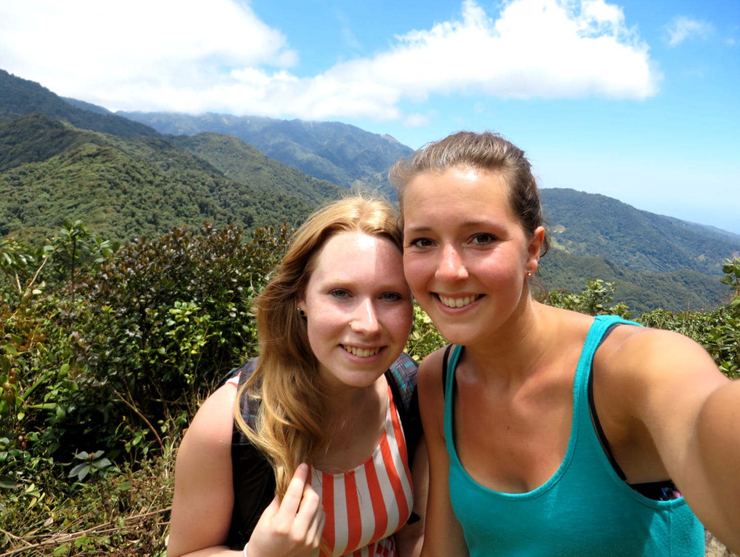 Two young women stand in front of a scenic vista in Panama.