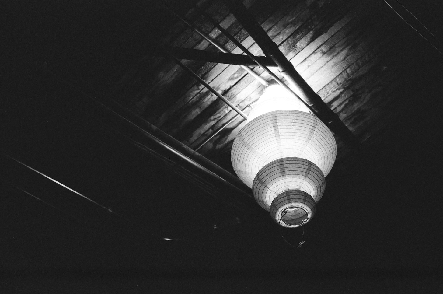 A black and white photo of an Asian lamp