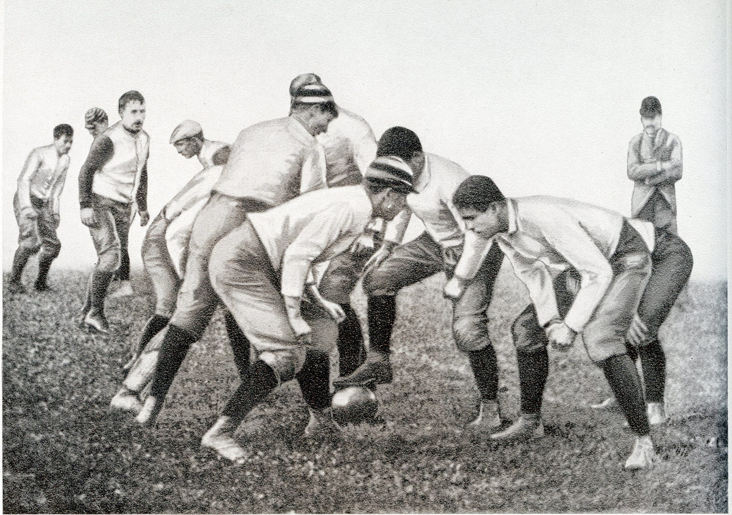 Center snapping ball with his foot in early 1880s.