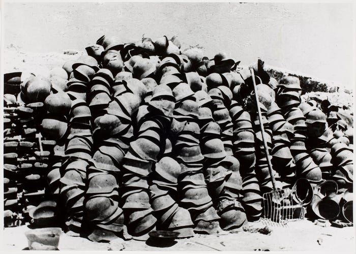 Piles of soldier helmets] | International Center of Photography