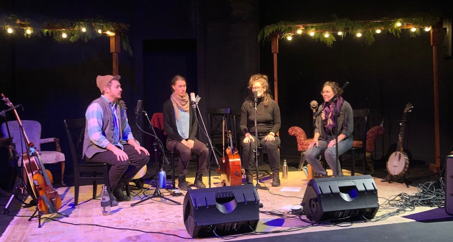 four singers on a stage