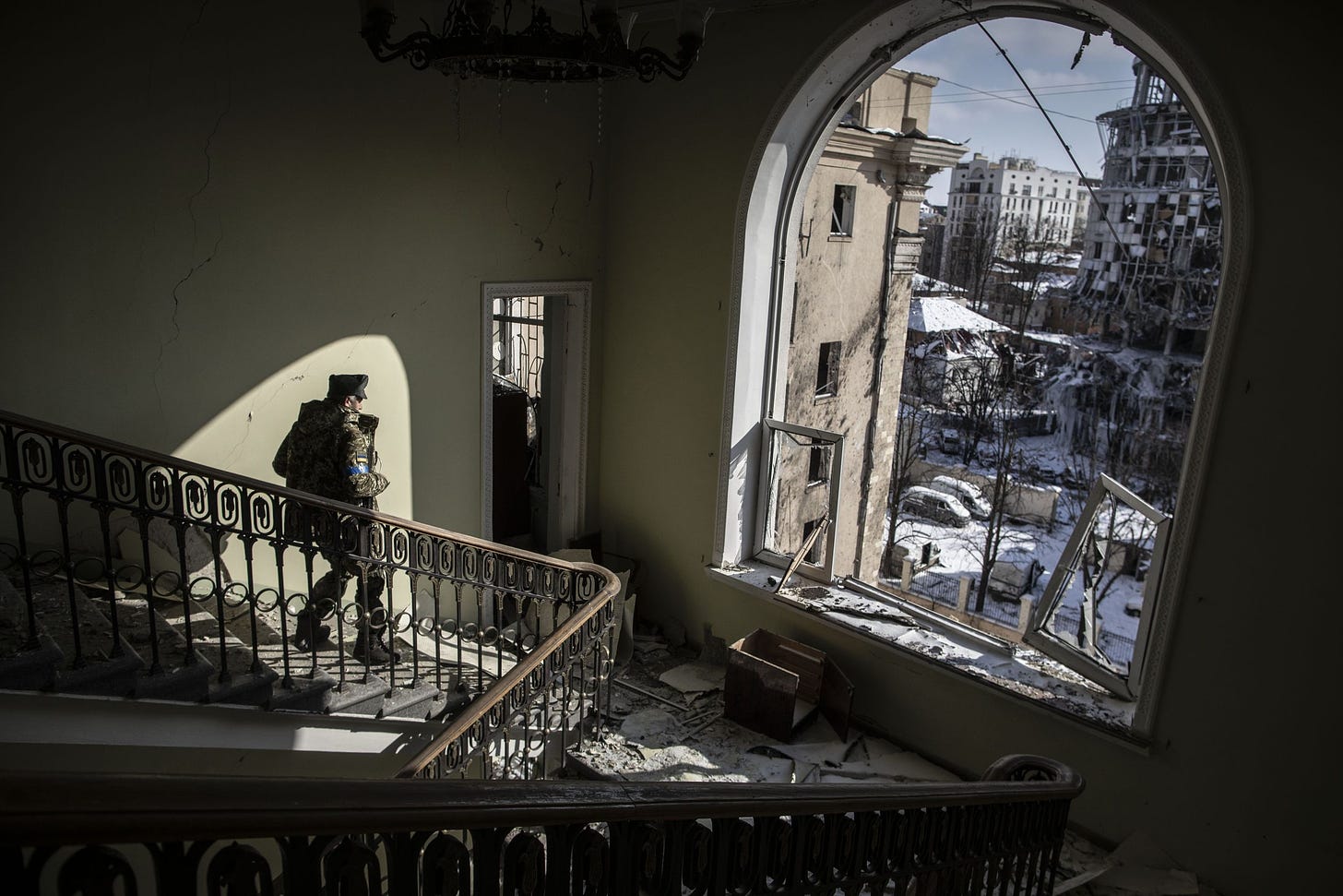 Ukranian soldier explores shelled building