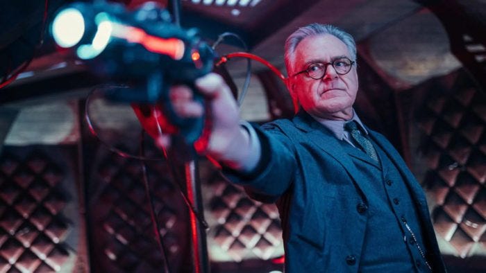 This image shows Professor Eustacious Jericho (played by Kevin McNally) pointing a Sontaran blaster toward screen left (and at an unseen enemy). This image shows Professor Eustacious Jericho (played by Kevin McNally) pointing a Sontaran blaster toward screen left (and at an unseen enemy).