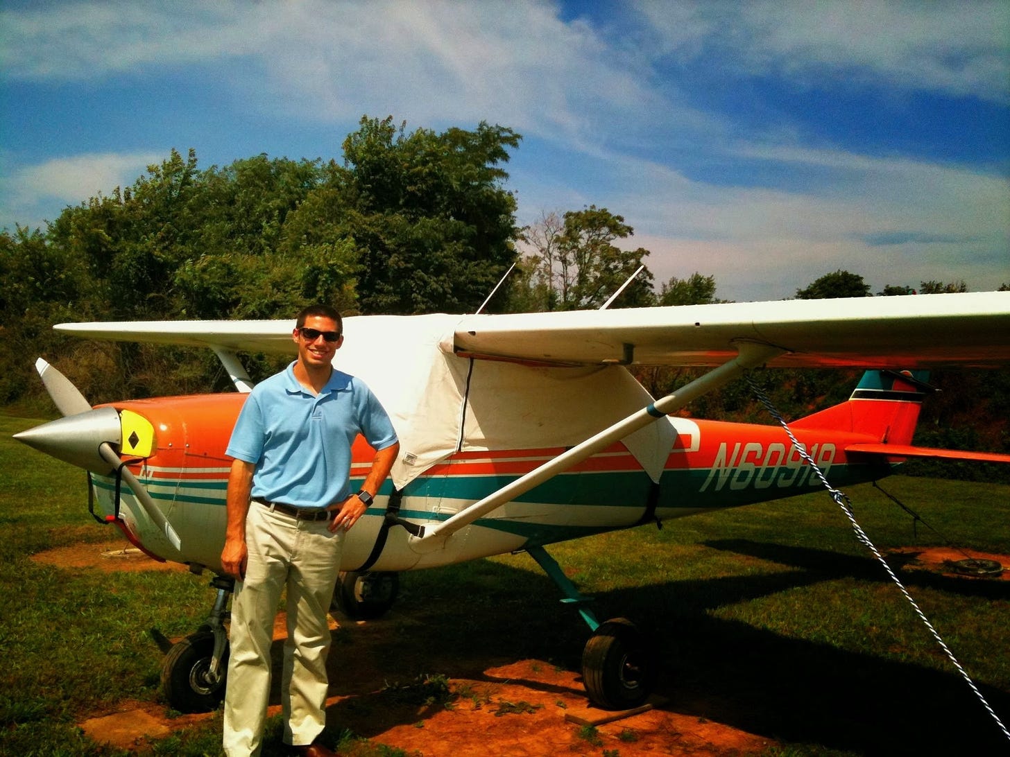 Aaron Aiken standing next to an airplane.