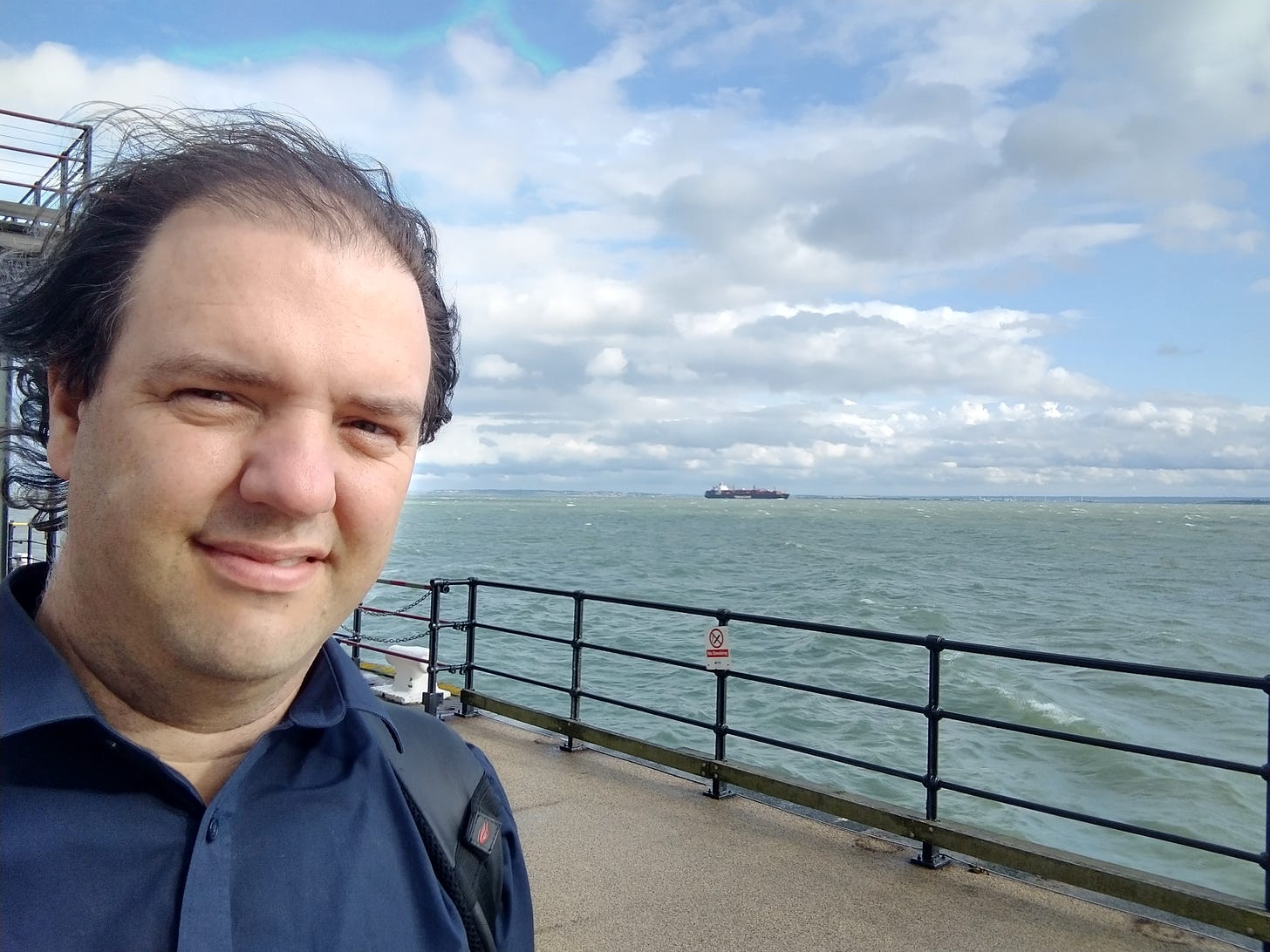 A picture of me, James Gleave, on the end of Southend Pier, with a container ship in the background