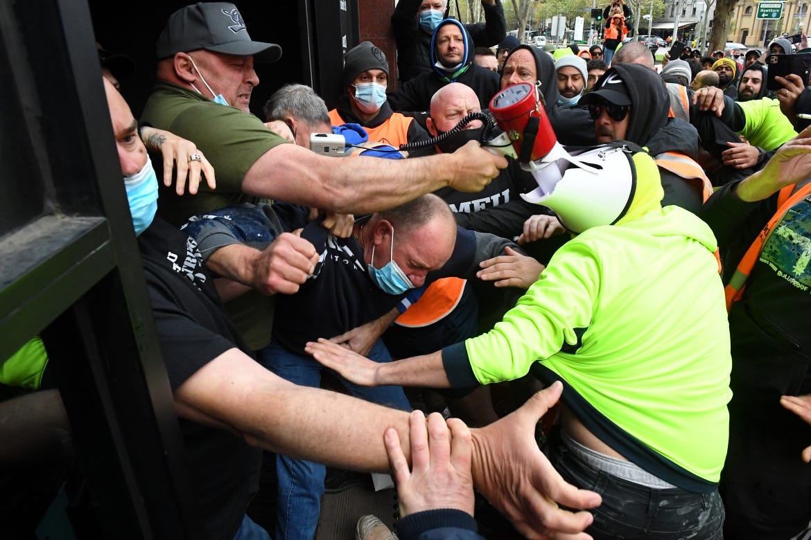 Construction workers clash with union representatives in front of Construction, Forestry, Maritime, Mining and Energy Union (CFMEU) headquarters in Melbourne. [James Ross/EPA]