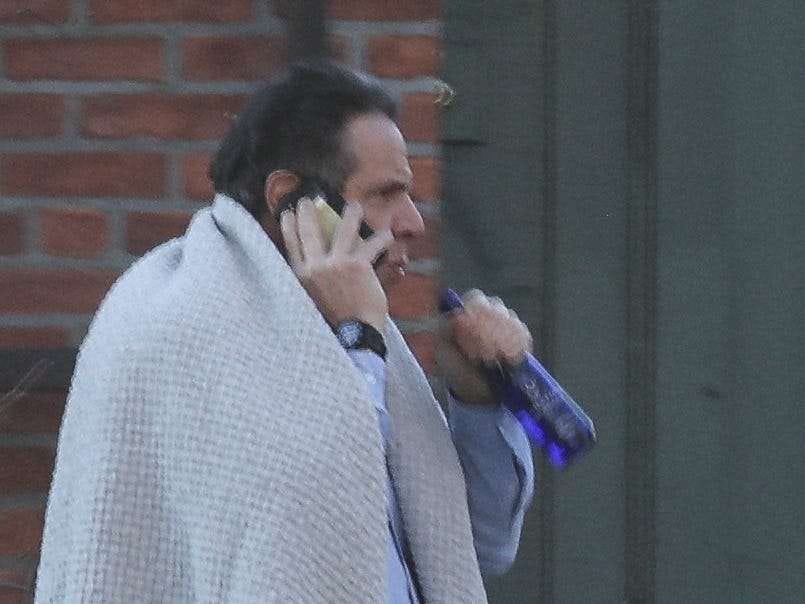 What is Cuomo clutching in a photo of him wrapped in a blanket, taken at  the end of a politically tumultuous week? | Business Insider India