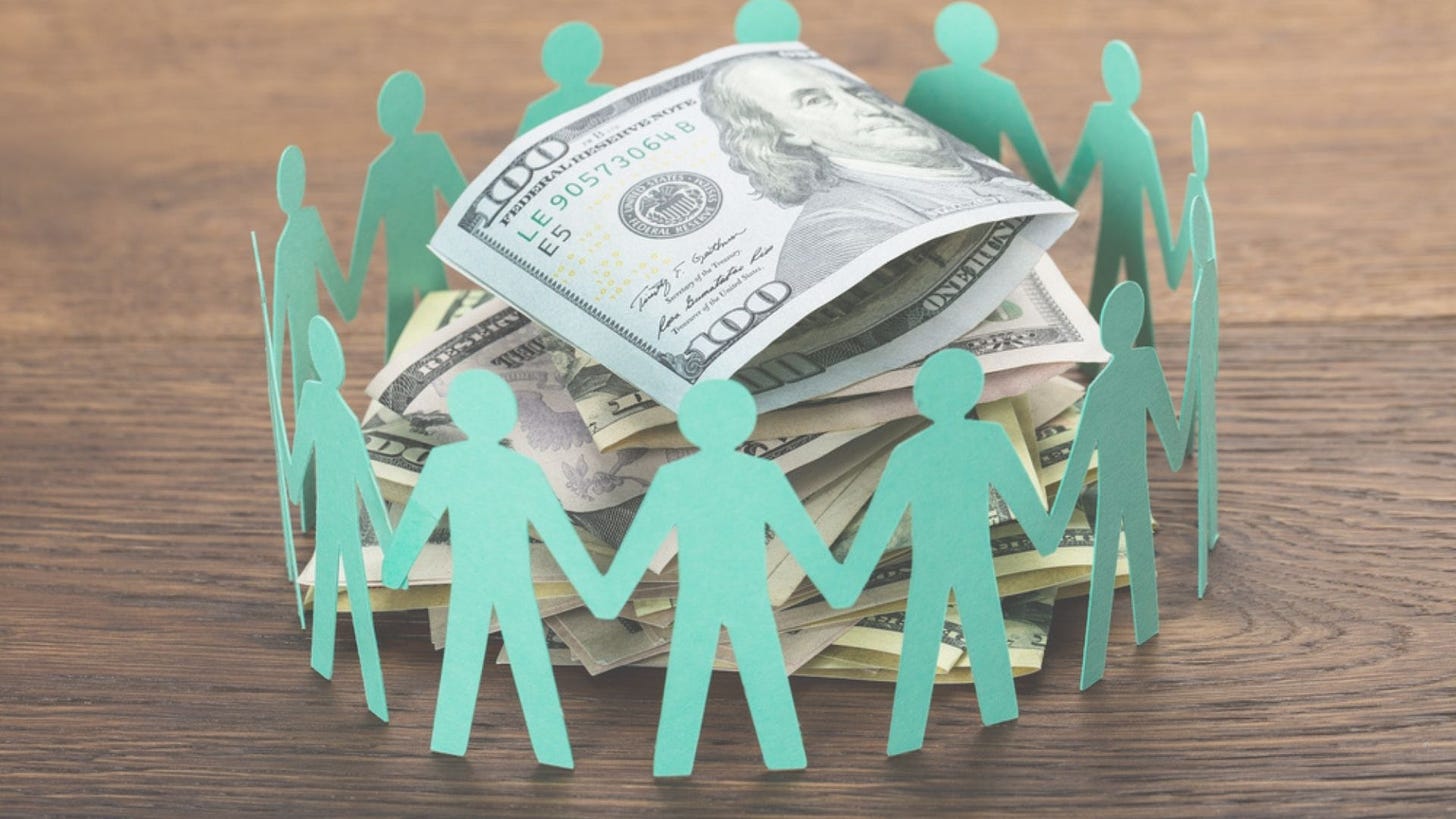 paper cut-out people holding hands around pile of hundred dollar bills
