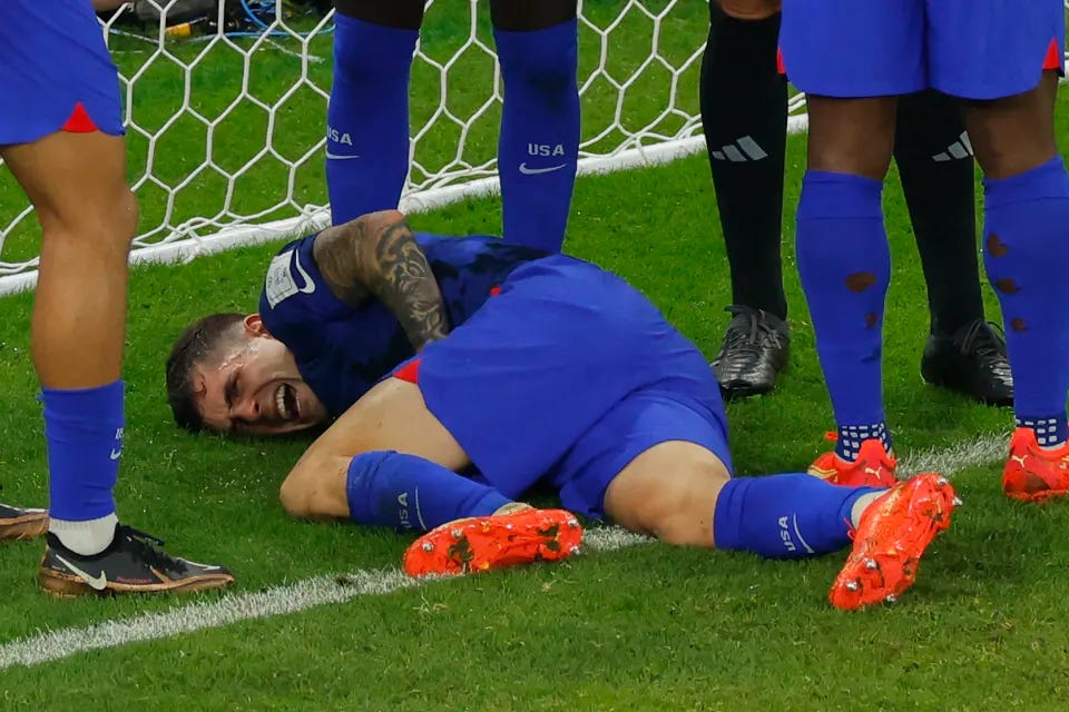 Christian Pulisic writhing in pain after taking one for the team.