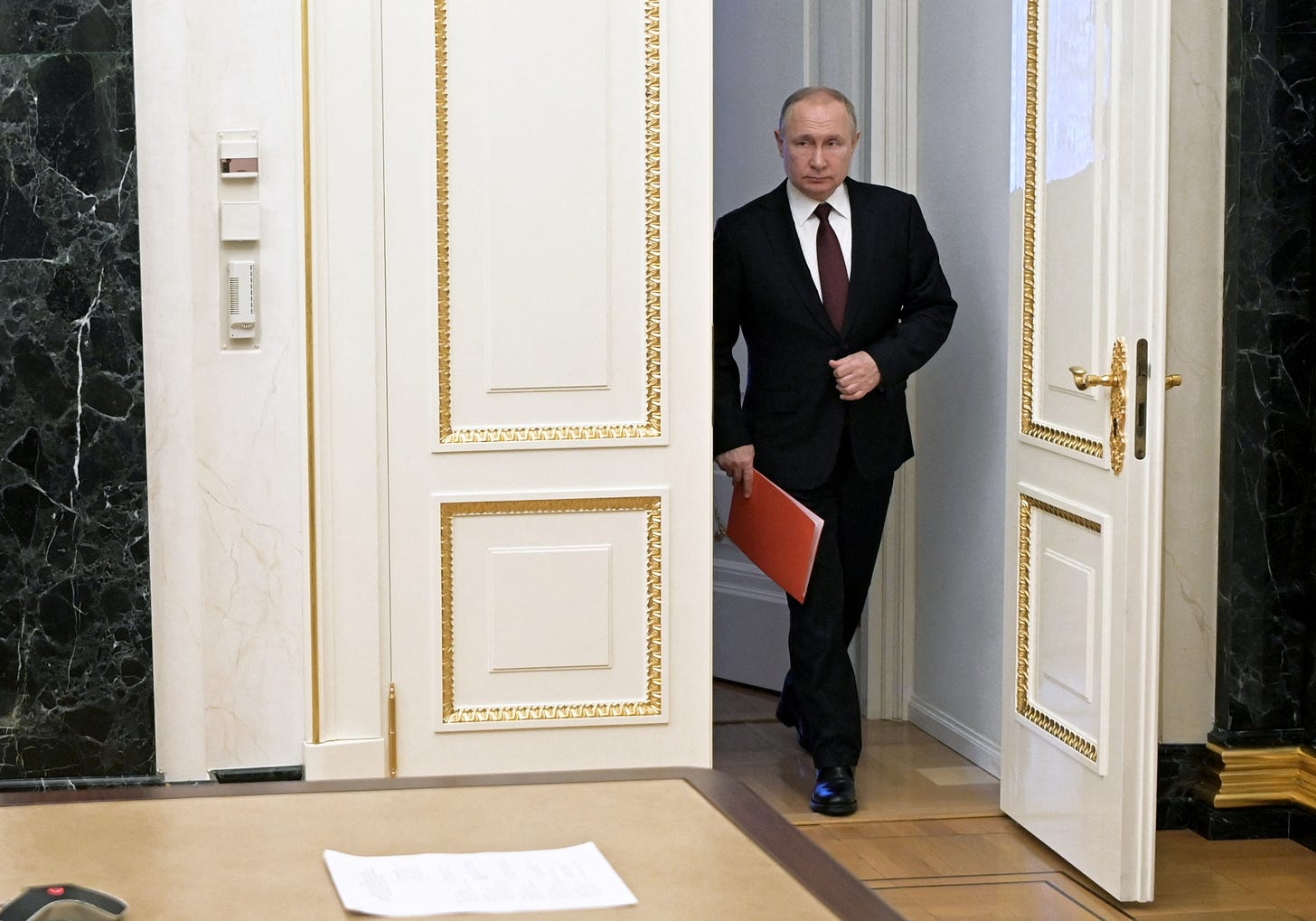 Russian President Vladimir Putin enters a hall before a meeting with members of the Security Council via a video link in Moscow, Russia February 25, 2022. Sputnik/Alexey Nikolsky/Kremlin