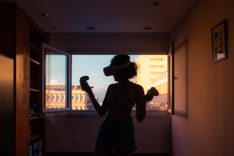 Silhouette of a person wearing a VR headset in a sunlit city apartment