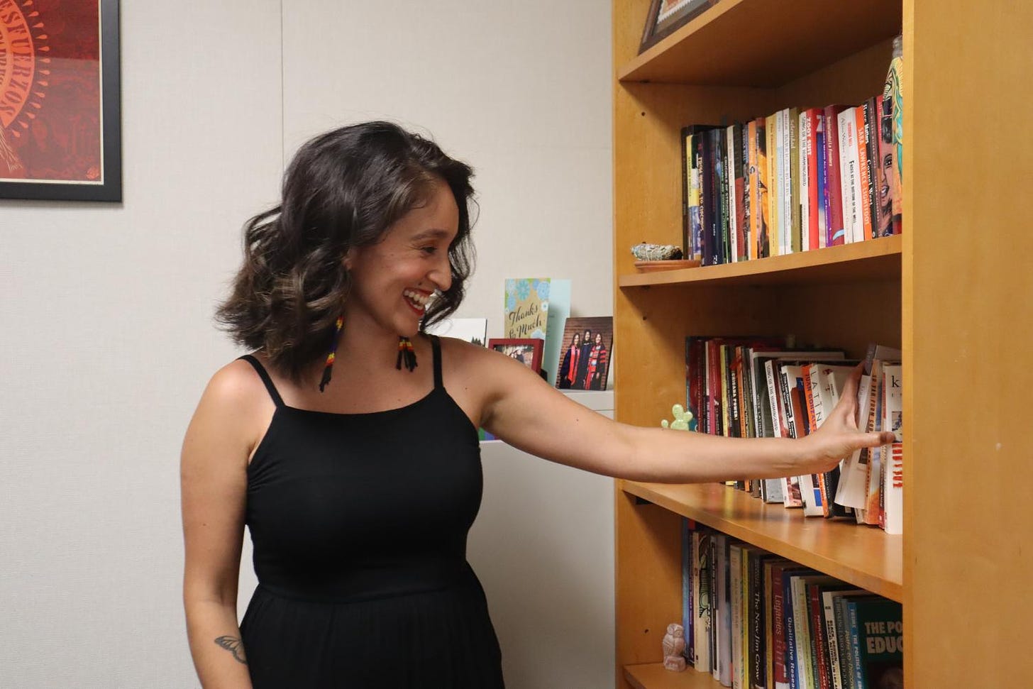 Education assistant professor Alma Flores pulls out a book from her library in her office at Sacramento State on Sept. 7, 2021.Flores said that on her first day of orientation she was one of four or two faculty Chicana out of 80 faculty. 