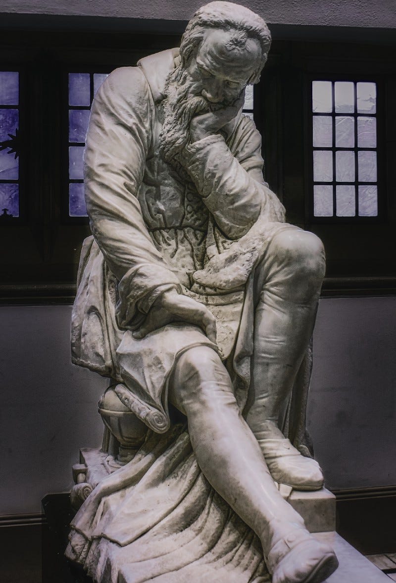 Statue of Man Sitting, Thinking, Pondering